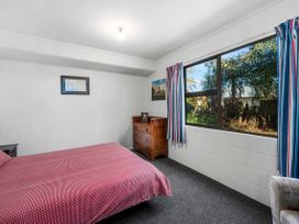 A bedroom with a bed and chest of drawers at Riverbed Lodge - Lake Taupo Home Tauranga Taupo