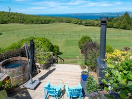 An outdoor space with a hot tub and chairs at Pukawa Country Lodge - Pukawa Bay