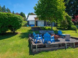 A garden with blue chairs and a fire pit at Pukawa Country Lodge - Pukawa Bay