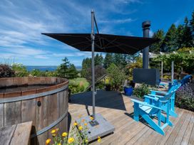 An outdoor area with a hot tub and chairs at Pukawa Country Lodge - Pukawa Bay