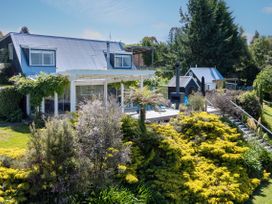 A house with a deck and garden at Pukawa Country Lodge - Pukawa Bay