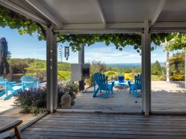 An outdoor seating area with chairs and a table at Pukawa Country Lodge - Pukawa Bay