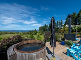 An outdoor area with a hot tub and seating at Pukawa Country Lodge - Pukawa Bay