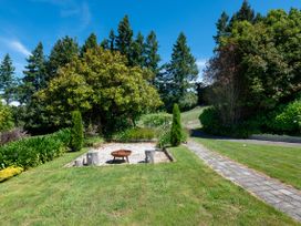A garden with a fire pit and pathway at Pukawa Country Lodge - Pukawa Bay