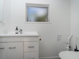 A bathroom with a sink and toilet at Patton's Place - Pauanui Holiday Home Pauanui