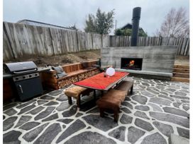 An outdoor area with seating and a barbecue grill at Lake Hawea Haven - Lake Hawea