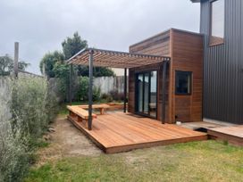 An outdoor area with a wooden deck and pergola at Lake Hawea Haven - Lake Hawea