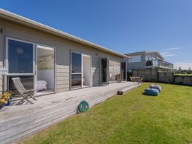 An outdoor area with a house and deck at Beachfront Beauty - Whangamata Beachfront Home, Whangamata