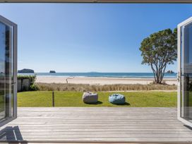 An outdoor area with two bean bags facing the beach at Beachfront Beauty - Whangamata Beachfront Home Whangamata