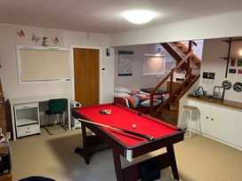 A game room with a pool table and a bed at Tranquility Base - Waikanae Beach Holiday Home Waikanae Beach