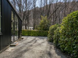 An outdoor area with a building and trees at Merioneth Retreat - Arrowtown Holiday Home