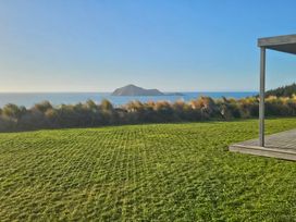 An outdoor space with grass and view of the sea at Waimarama Heights - Waimarama