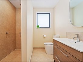 A bathroom with a shower, toilet, and sink at Slice of Pauanui - Pauanui Holiday Home in Paunui