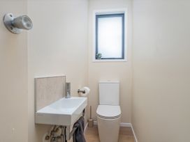 A bathroom with a sink and toilet at Slice of Pauanui - Pauanui Holiday Home in Pauanui