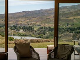 A view of the river and mountains from a window at Vino and Views - Bannockburn Holiday Home in Cromwell