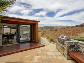 An outdoor area with a grill and stone pathway at Vino and Views - Bannockburn Holiday Home, Cromwell
