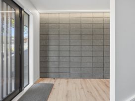 An entryway with a large window and grey wall at Rolki House - Hanmer Springs