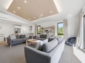 A living room with sofas and a coffee table at Rolki House - Hanmer Springs