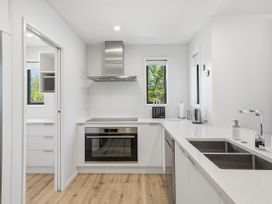 A kitchen with appliances and modern fixtures at Rolki House - Hanmer Springs