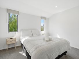 A bedroom with a bed and bedside table at Rolki House - Hanmer Springs