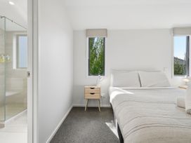 A bedroom with a bed and nightstand at Rolki House - Hanmer Springs