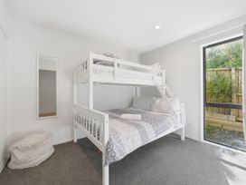 A bedroom with a bunk bed and a window at Rolki House - Hanmer Springs
