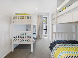 A bedroom with bunk beds and a window at Rolki House - Hanmer Springs Holiday Home