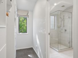 A bathroom with a shower and a window at Rolki House - Hanmer Springs