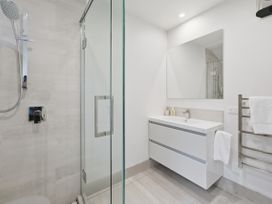 A bathroom with a shower and sink at Rolki House - Hanmer Springs Holiday Home Hanmer Springs
