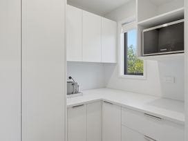A kitchen with cabinets and a countertop at Rolki House - Hanmer Springs