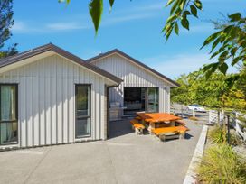 A house with a patio and outdoor furniture at Rolki House - Hanmer Springs