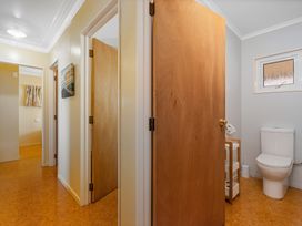 A bathroom with a toilet and sink at Poppy's Beach House - Beachfront Whangapoua Home
