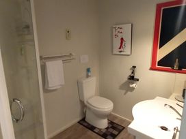A bathroom with a shower, toilet, and sink at Havenbrooke - Kerikeri Holiday Home, Kerikeri