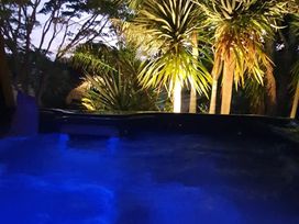 A hot tub surrounded by plants at Havenbrooke - Kerikeri Holiday Home in Kerikeri