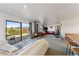 A living room with a sofa and fireplace at Adventure Seekers Lodge - National Park