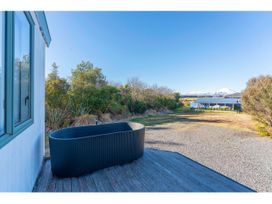A bathtub on a deck with a view of garden and mountains at Adventure Seekers Lodge - National Park