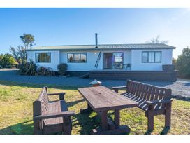 An outdoor area with a table and chairs at Adventure Seekers Lodge - National Park