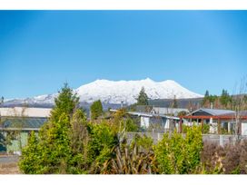 A view of a snow-covered mountain with houses and trees at Adventure Seekers Lodge - National Park Retreat, National Park