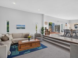 A living room with a sofa and coffee table at Pohutukawa Peace - Mangawhai Holiday Home Mangawhai Village