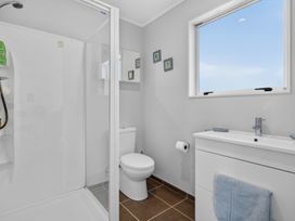 A bathroom with a shower and sink at Pohutukawa Peace - Mangawhai Holiday Home, Mangawhai Village