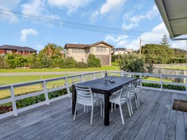 A patio with a table and chairs at Matapouri Magic - Matapouri