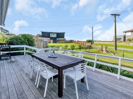 An outdoor dining area with a table and chairs at Matapouri Magic - Matapouri