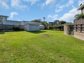 A garden with a shed and water tank at Matapouri Magic - Matapouri