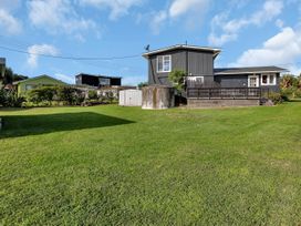 A house with a deck and garden in Matapouri Magic - Matapouri