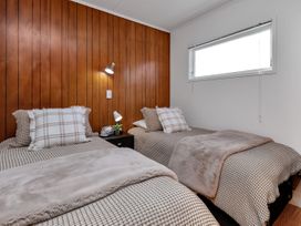 A bedroom with two beds and a window at Matapouri Magic - Matapouri