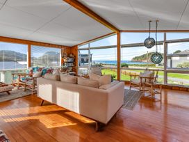 A living room with a sofa and chairs at Matapouri Magic - Matapouri