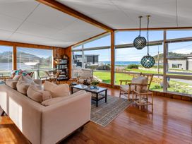 A living room with a sofa and coffee table at Matapouri Magic - Matapouri