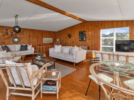 A living room with seating and a television at Matapouri Magic - Matapouri