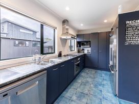 A kitchen with appliances and countertops at Manaia Magic - Tairua Holiday Home, Tairua