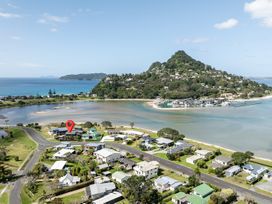 An outdoor view of a coastal area with houses and a mountain at Manaia Magic - Tairua Holiday Home in Tairua